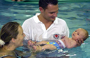 Foto: DRK-Trainer mit Baby beim Schwimmen.